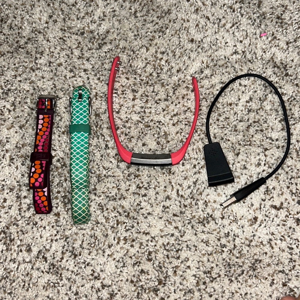 FitBit Alta activity tracker with charger and couple bands